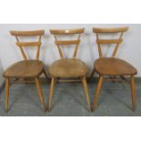 Three mid-century elm and beech ‘green dot’ stacking chairs by Ercol, on canted supports with an ‘H’