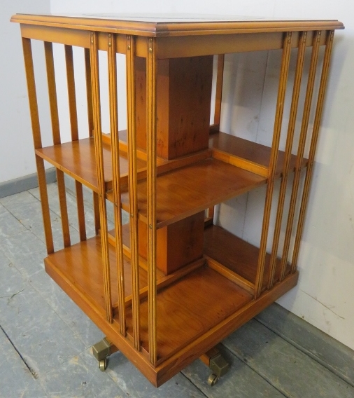 A reproduction cross-banded yew wood revolving book table, with inset gilt tooled green leather top. - Image 2 of 3