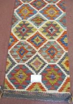 A Chobi Kilim runner, colourful repeat pattern. Good strong colours and condition. 164cm x 61cm.