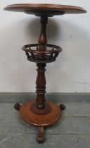 A Victorian mahogany circular lamp table, supported on a baluster turned column having a basket with