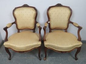 A pair of vintage French Louis XV style carved show-wood open-sided armchairs, upholstered in