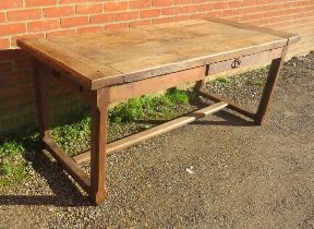 A 19th century rustic French farmhouse kitchen table of good patina, having a side drawer and an end