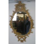 A highly decorative Georgian revival carved giltwood wall mirror, 20th century, decorated with