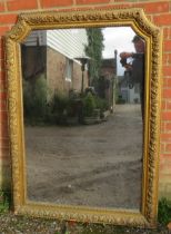 A large 19th century French giltwood wall mirror, of rectangular form with swept inverted top