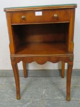 A reproduction yew wood bedside cabinet, housing one long cock-beaded drawer with brass handles,