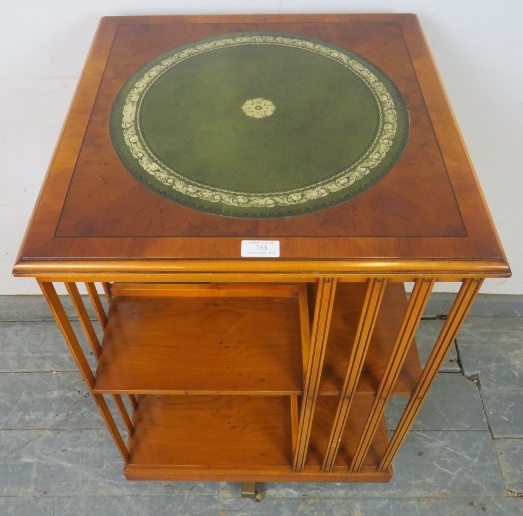 A reproduction cross-banded yew wood revolving book table, with inset gilt tooled green leather top. - Image 3 of 3