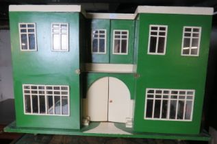 A c.1930's scratch-built Art Deco dolls house, painted green and white. Some old electrics fitted