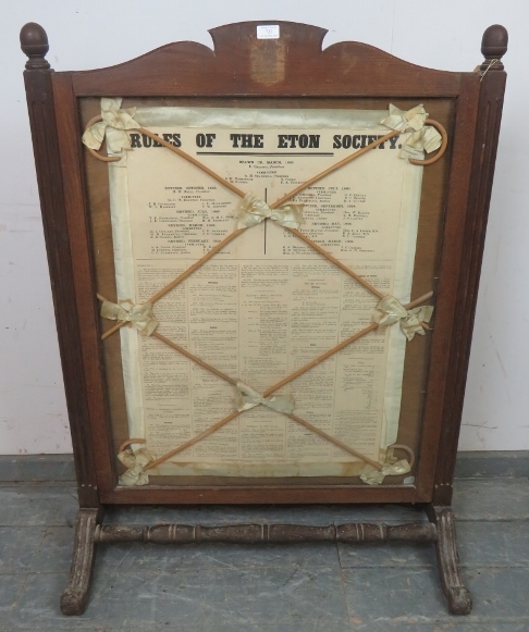 A large antique firescreen featuring ‘The Rules of Eton’ within an oak frame, having reeded uprights