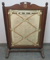 A large antique firescreen featuring ‘The Rules of Eton’ within an oak frame, having reeded uprights