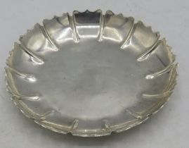 A small silver circular dish with decorative edge, London 1964, C.J Vander. Approx weight 3.5 troy