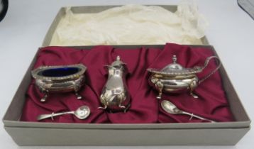 A silver three piece condiment set with matching salt & mustard spoon, Sheffield 1988, blue