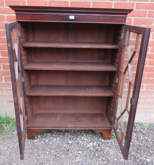 A George III mahogany enclosed bookcase, having a dentil cornice above astral glazed doors, - Image 2 of 2