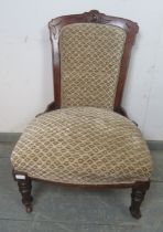 A late Victorian mahogany show-wood bedroom chair, reupholstered in patterned chenille material,