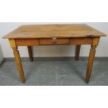 An antique stripped pine kitchen table, single frieze drawer, fitted legs. W112cm H74cm D67cm (