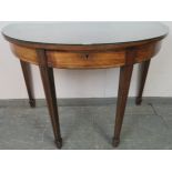 A Georgian mahogany demi-lune serving table strung with ebony, housing three blind drawers, on