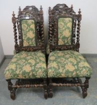 A set of four 19th century Carolean Revival carved oak dining chairs, with busy foliate