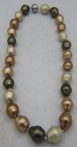 A multi coffee coloured synthetic pearl necklace, 20" length. Each pearl 17mm and individually
