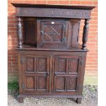 A 17th century and later oak court cupboard, the top section with central cupboard flanked by relief