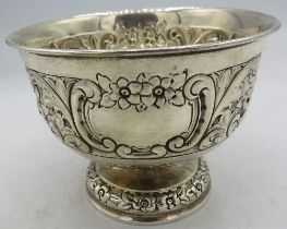 A small silver pedestal bowl with plain cartouche, embossed with scrolls and flowers, London 1900.