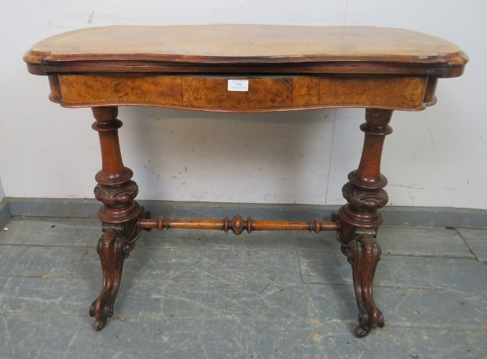 A Victorian figural walnut card table, the serpentine rectangular top with inverted rounded corners,