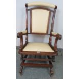 An early 20th century American mahogany ‘Dexter’ rocking chair, re-upholstered in cream leather with