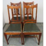 Four Arts & Crafts mahogany dining chairs by Maple & Co, having pierced backrests and seats