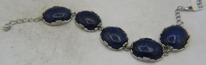 A white metal five cabochon linked lapis lazuli bracelet. Approx 52 grams. Condition report: One
