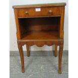 A reproduction yew wood bedside cabinet, housing one long cock-beaded drawer with brass handles,