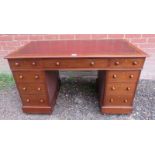 A 19th century walnut pedestal desk, having inset gilt tooled burgundy leather surface, housing a