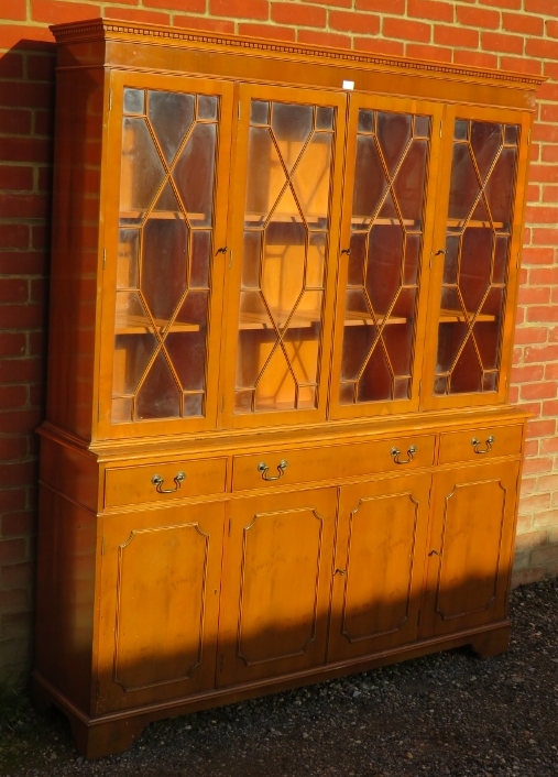 A reproduction yew wood library bookcase, having a dentil cornice above four astral glazed doors, - Image 2 of 3