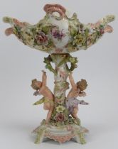 A German porcelain centrepiece florally decorated with cherubs, late 19th century. Unmarked,
