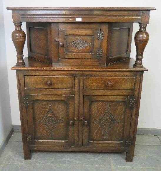 A good solid early 20th century court cupboard in the late 17th century style, good carved panels,