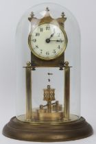 A gilt metal and brass 400 Day Anniversary torsion pendulum clock with glass dome, early 20th