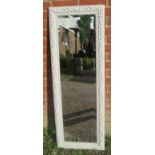 A contemporary bevelled dressing mirror, in an acanthus moulded frame painted white. H131cm W46cm (