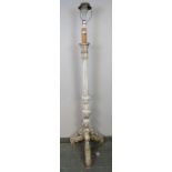 An ornate vintage standard lamp in the Florentine taste painted white, the fluted column on acanthus