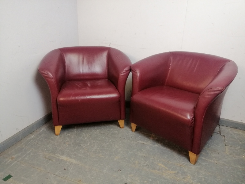 A pair of contemporary tub chairs by Grassoler, upholstered in burgundy leather, on triangular beech