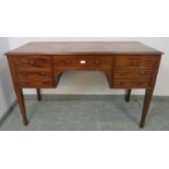 A 19th century mahogany kneehole dressing table/desk, the configuration of cock-beaded drawers above