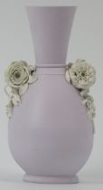 A lilac ground jasperware vase with applied floral decoration in relief. Probably by Wedgwood and