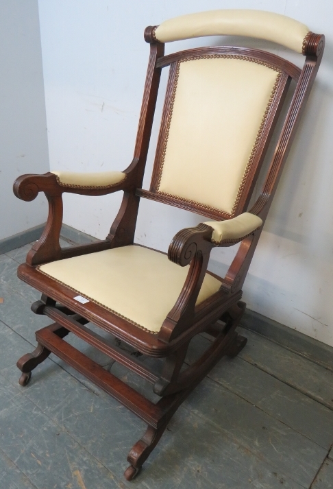 An early 20th century American mahogany ‘Dexter’ rocking chair, re-upholstered in cream leather with - Image 2 of 4