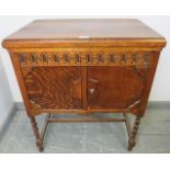 A 1920s oak cased floor-standing gramophone by Atlas, on barley twist supports with an ‘H’