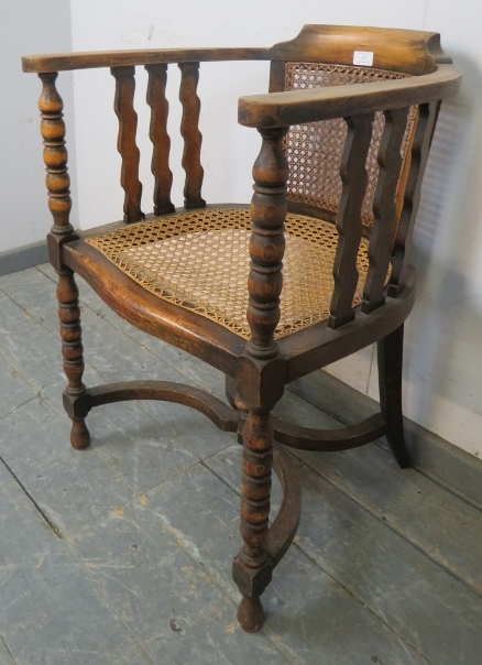 An antique fruitwood Continental bergère tub chair, the curved arms joined by shaped spindles and - Image 2 of 4