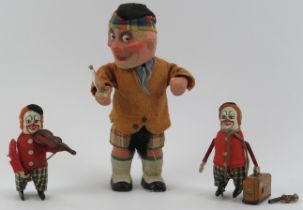 Three vintage clockwork tinplate toy model figures. Comprising a Schuco violin playing clown, a