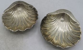 A pair of shell shaped butter dishes, Birmingham 1911, approx weight 1.6 troy oz/49 grams. Condition