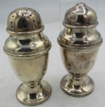 A pair of silver pedestal salt & pepper pots, Birmingham 1931. Approx weight 2.2 troy oz/68 grams.