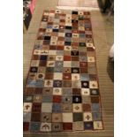 A woven woolen long rug of tile design.