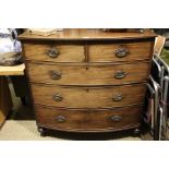 A 19th century mahogany bow front chest of five drawers on turned feet.