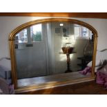 A modern plain gilt framed arched top over-mantel mirror