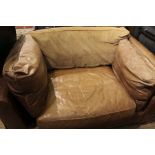 A modern design part leather love seat with fabric back pad.