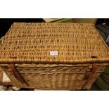 A large woven wicker hamper with provision for six bottles.
