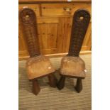 A pair of spinning chairs, carved with English Roses to the backs & a rabbit motif underneath